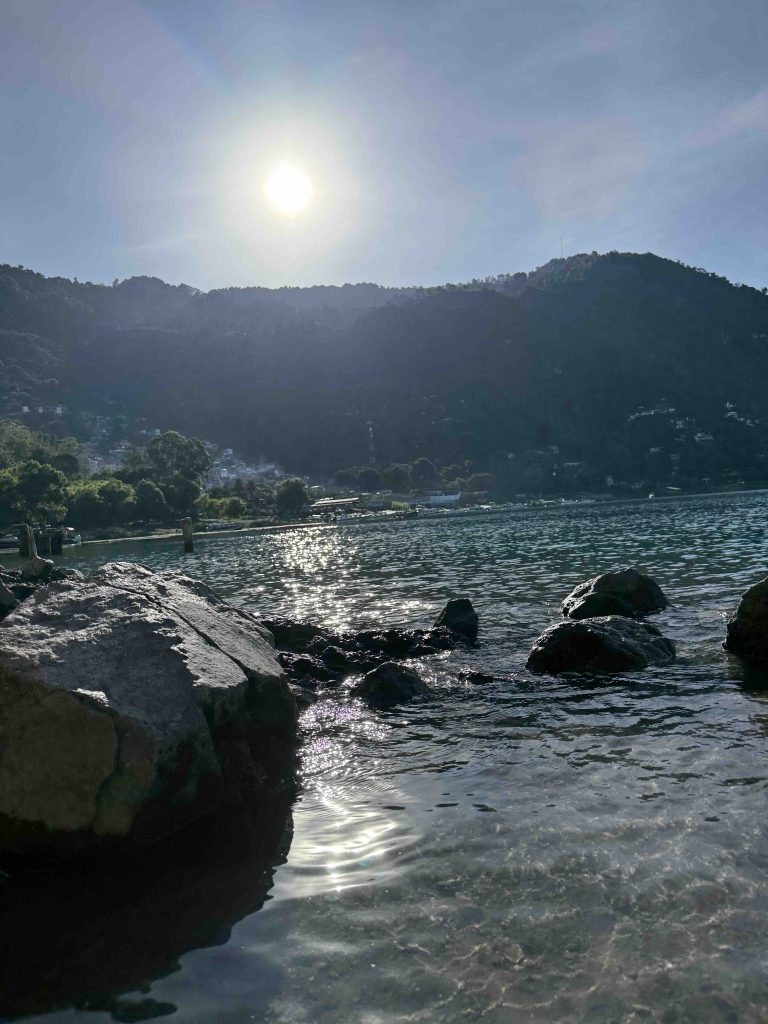 Morning sun shining over hills and sparkling water at the hot springs of Santa Catarina Palopó