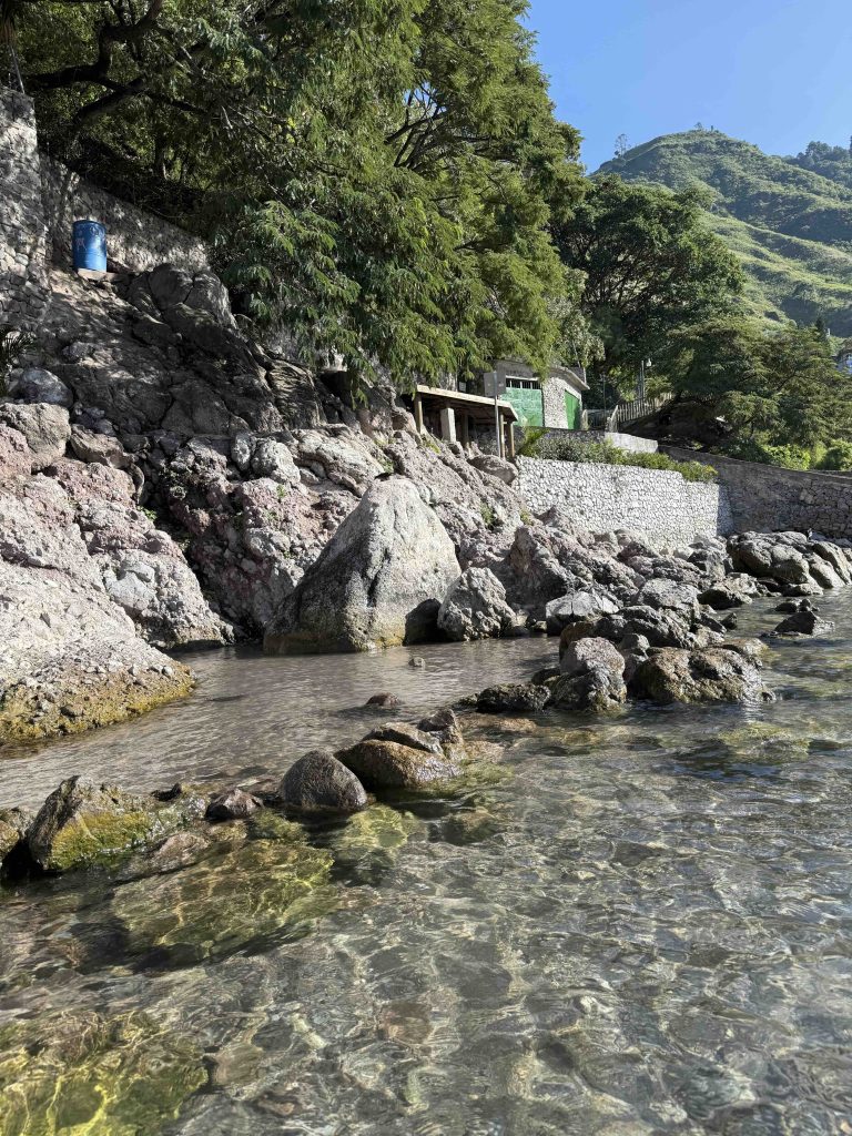 Natural rock pools and stone walls along the lakeside hot springs in Santa Catarina Palopó