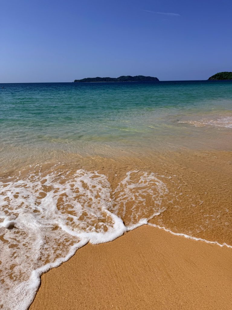 Gentle waves on the sandy shore at Nacpan Beach in El Nido, Palawan, Philippines.