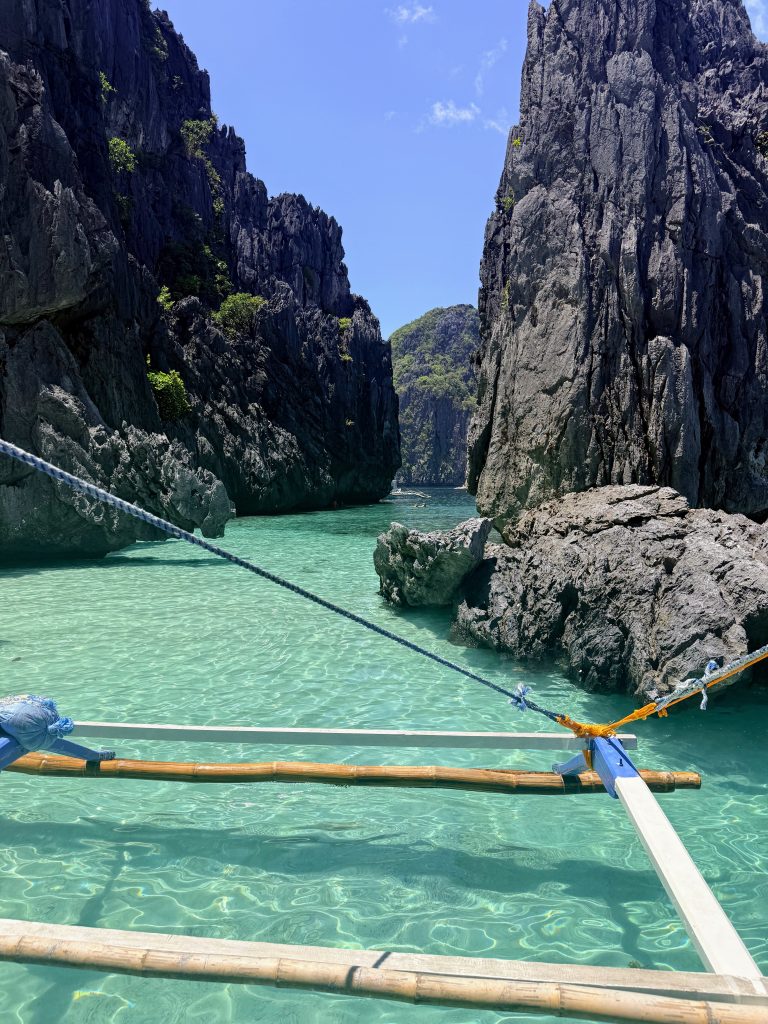 Clear turquoise water and limestone walls at the entrance to Secret Lagoon during Tour A island hopping in El Nido, Palawan, Philippines.