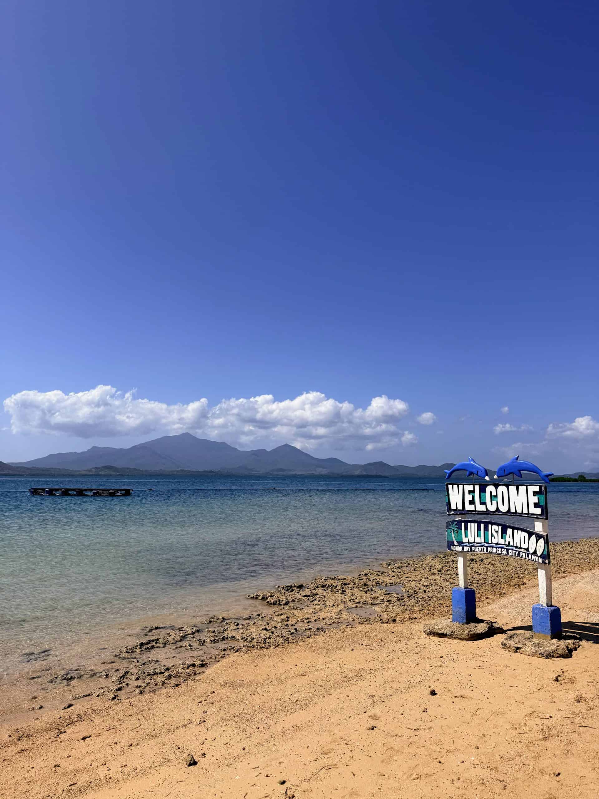 Welcome sign on the beach at Luli Island during Honda Bay island hopping in Puerto Princesa, Philippines.