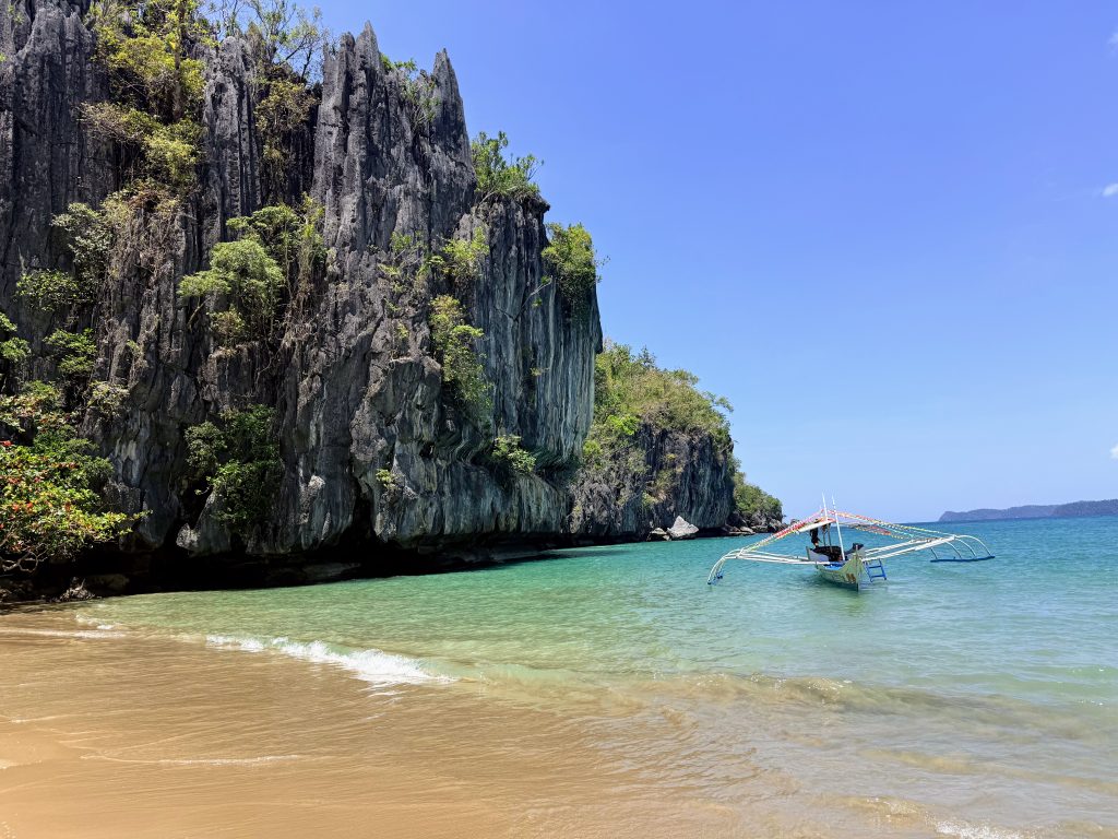 Limestone cliffs and clear shallow water at Puerto Princesa Subterranean River National Park in Palawan, Philippines.