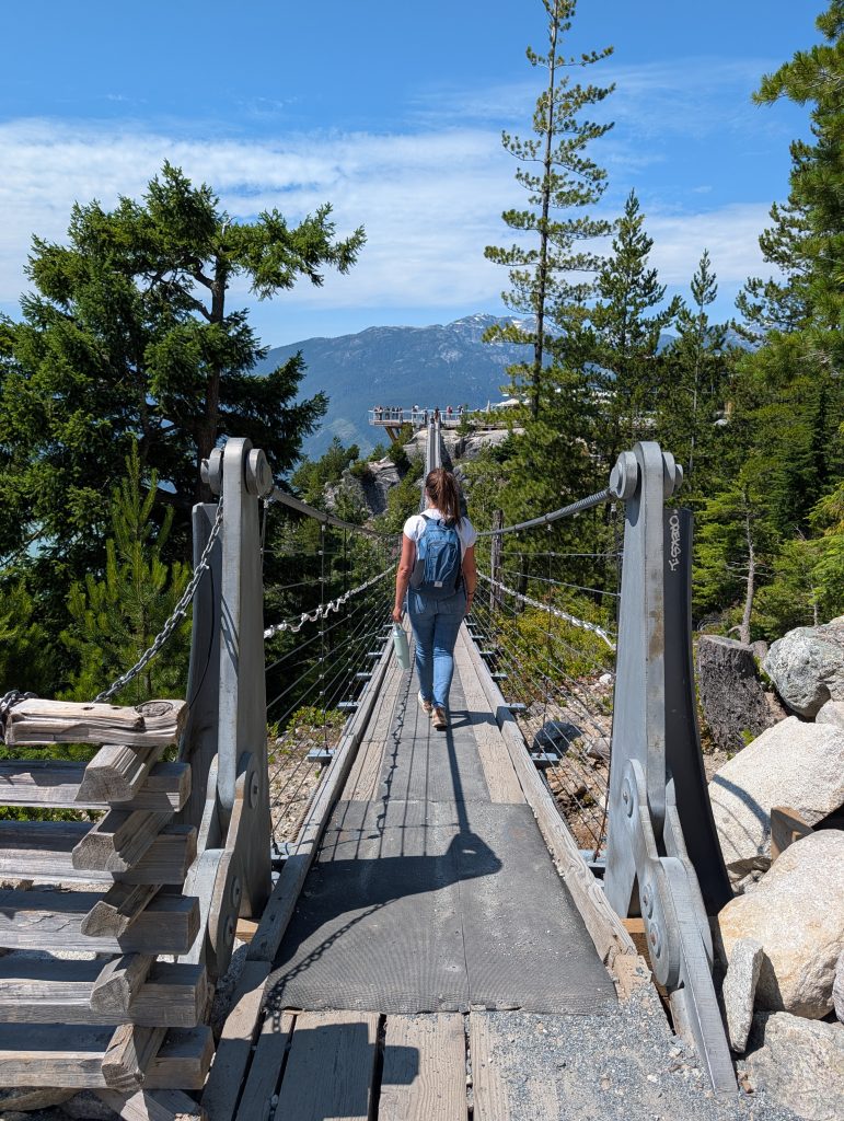 Visitor walking across the Sea to Sky Gondola suspension bridge