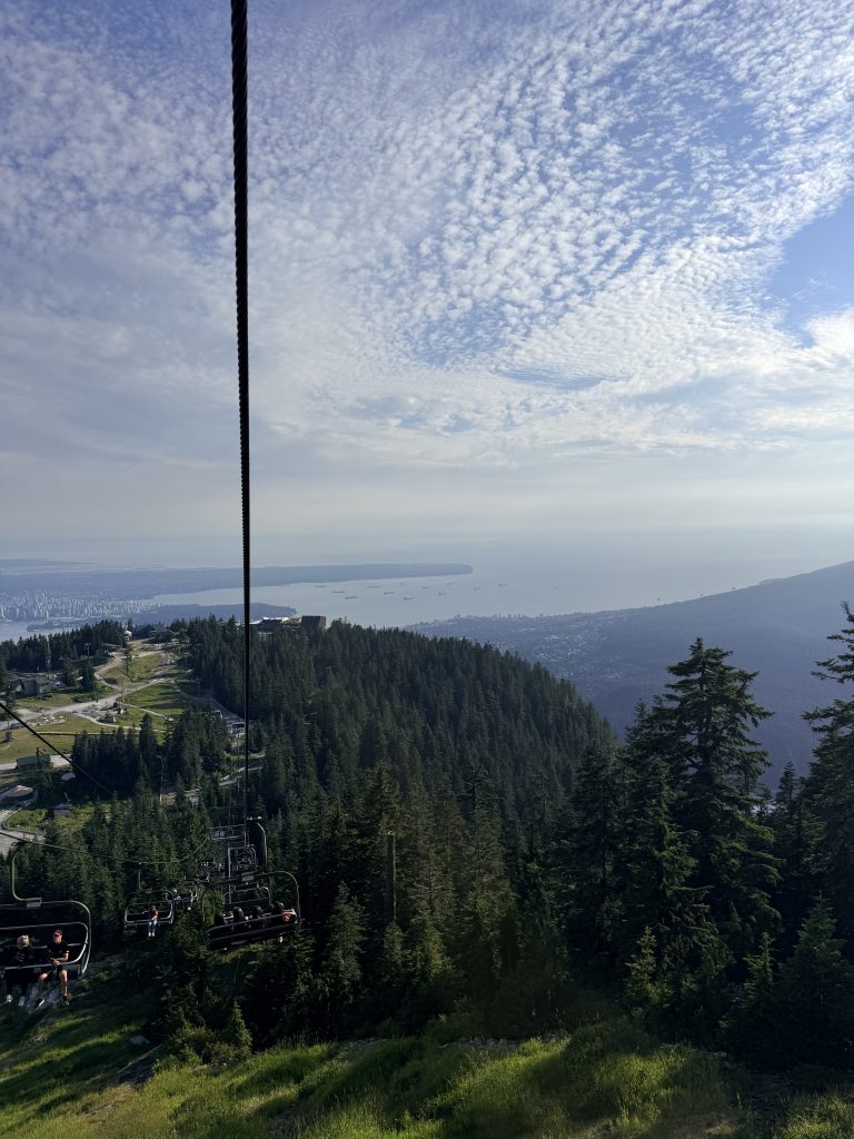Grouse Mountain chairlift with a panoramic view of Vancouver, Burrard Inlet and the city below.