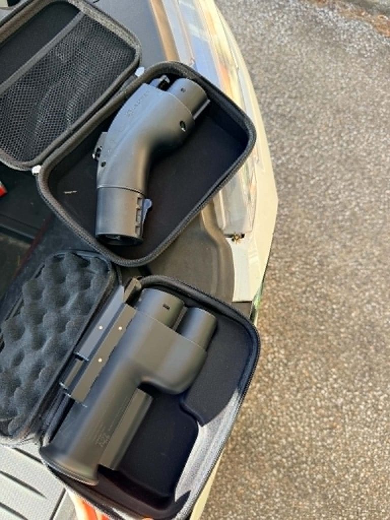 NACS charging adapters stored in cases for a Ford Mustang Mach-E EV road trip across Canada.