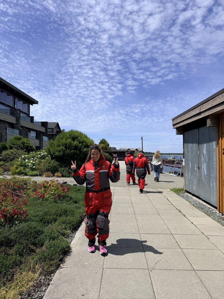 Woman in a red flotation suit getting ready for a whale watching tour in Tofino.