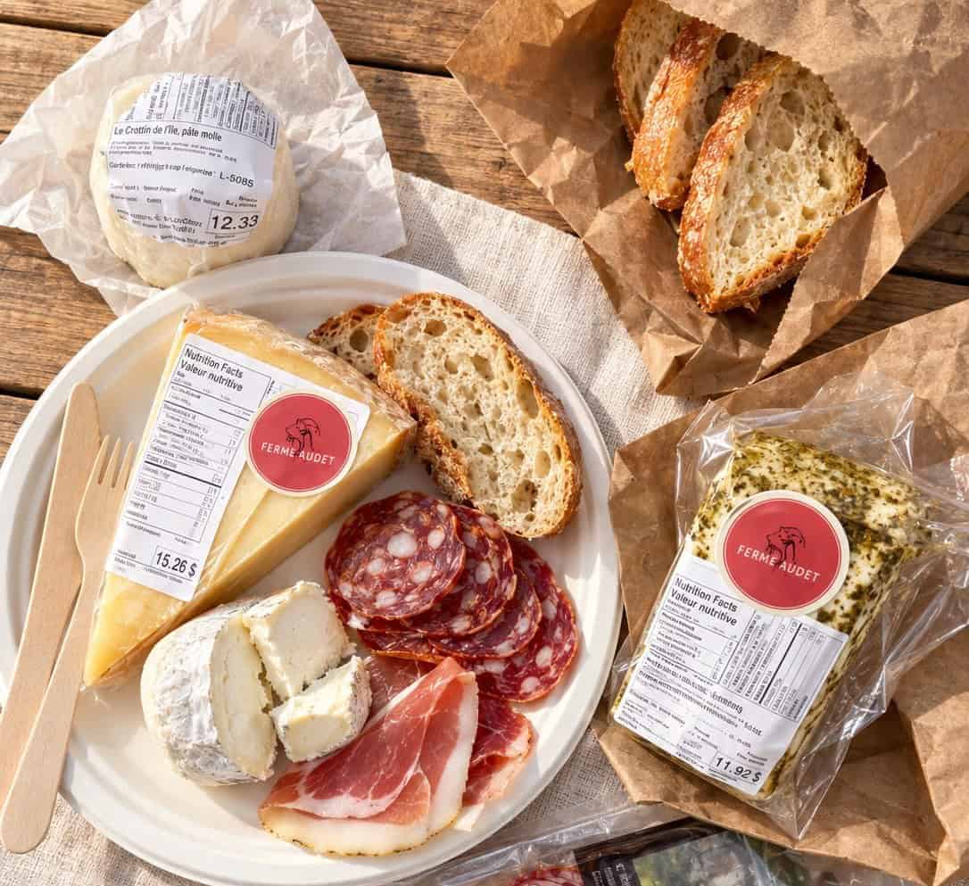 Ferme Audet goat cheeses served with bread and charcuterie during a picnic on Île d’Orléans.