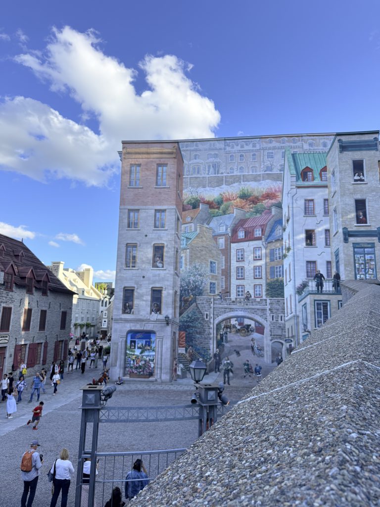 Fresque des Québécois mural in Old Quebec depicting historic buildings and figures from Quebec City.