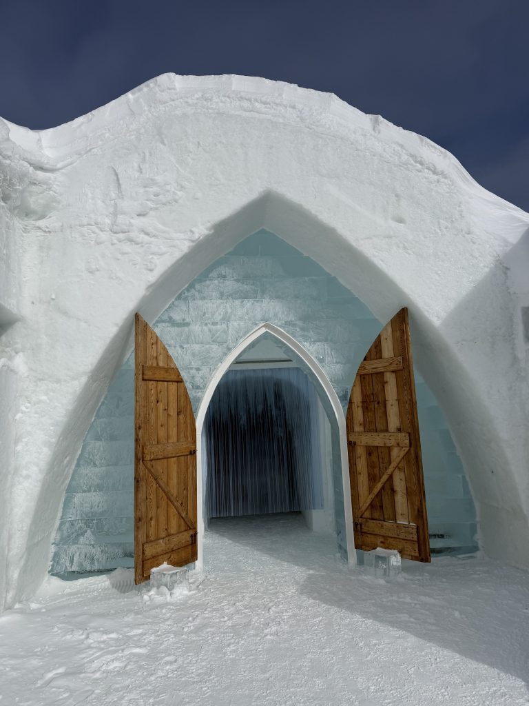 Snow and ice entrance with wooden doors at the Hôtel de Glace near Quebec City