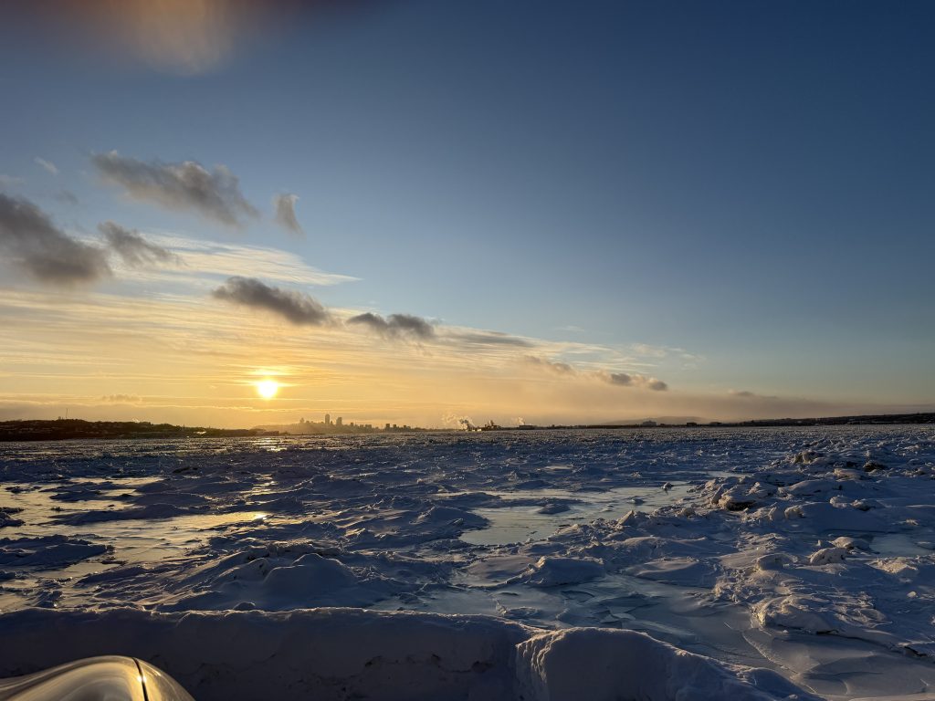 Winter sunset over the frozen St. Lawrence River from Île d'Orléans near Quebec City