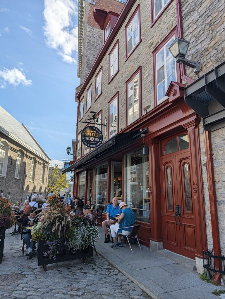 Maison Smith café patio beside historic stone buildings at Place Royale in Quebec City.