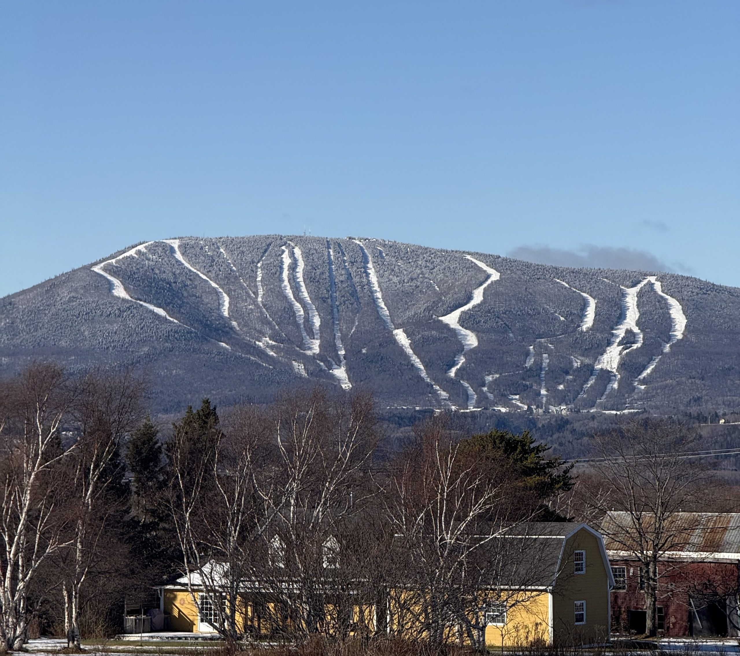 Mont-Sainte-Anne ski resort near Quebec City with snow-covered ski runs across the mountain on a clear winter day.