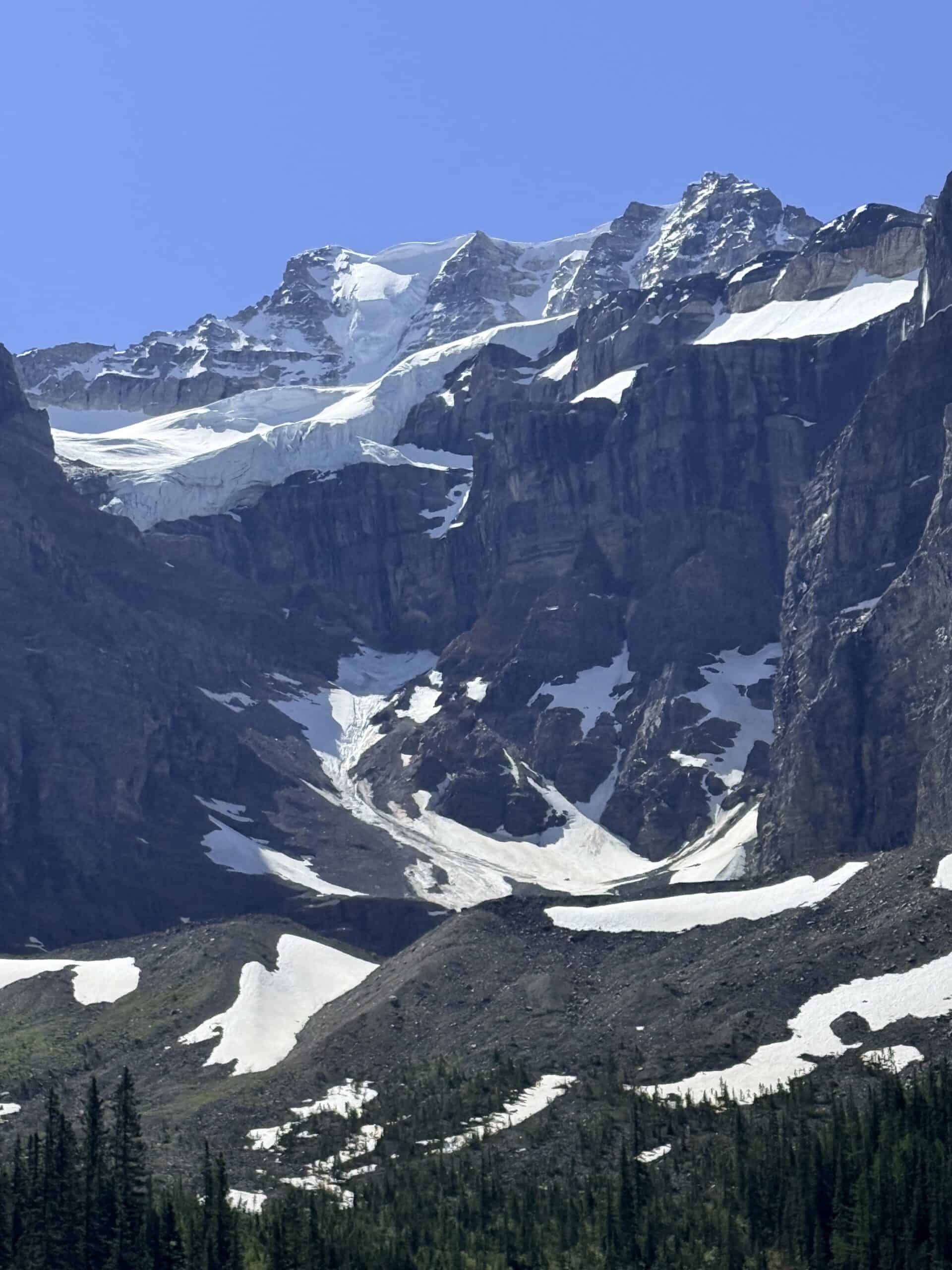 Snow-covered mountain peaks rising above Moraine Lake in Banff National Park