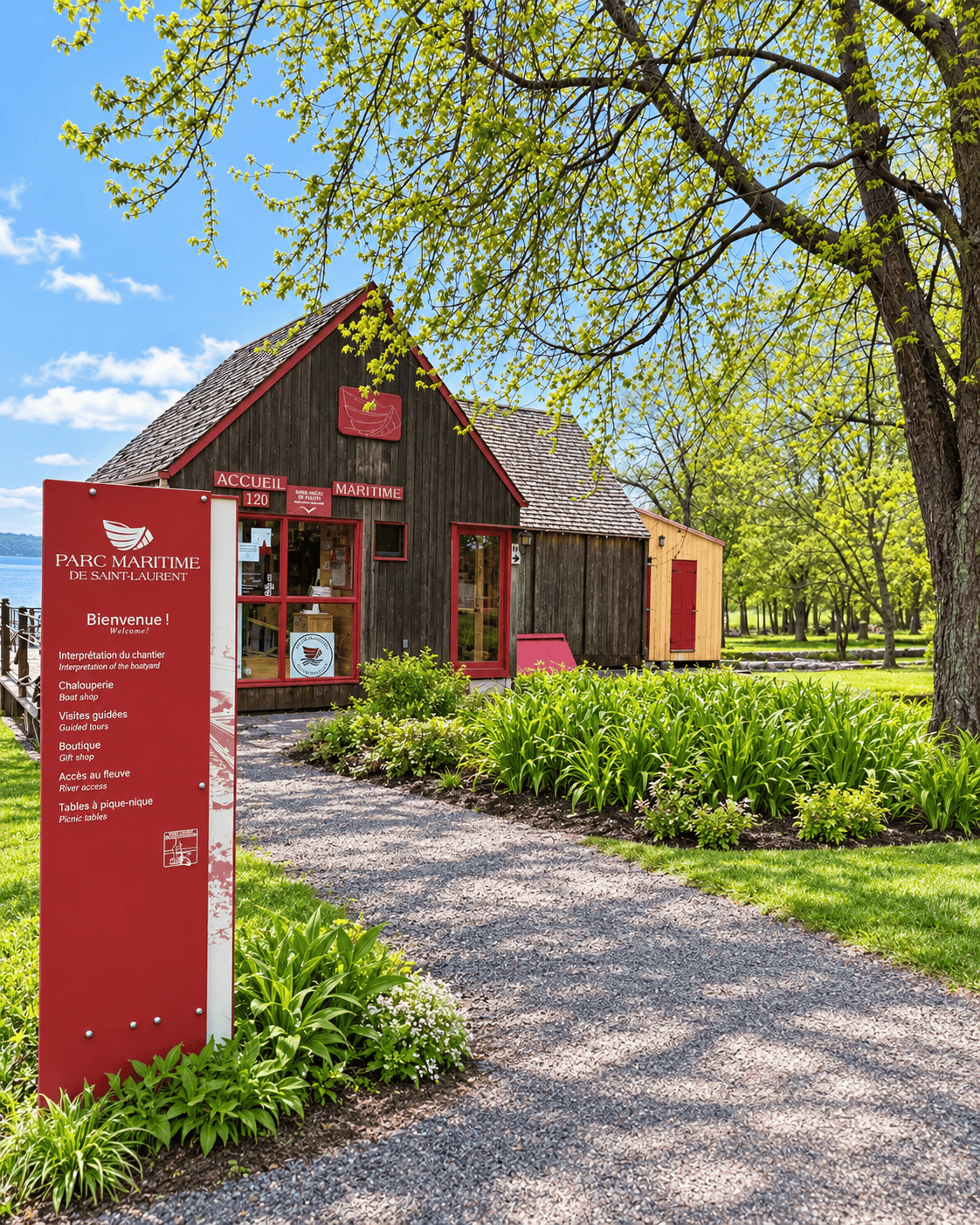 Parc maritime de Saint-Laurent on Île d’Orléans, with its historic wooden building surrounded by trees on a sunny day.
