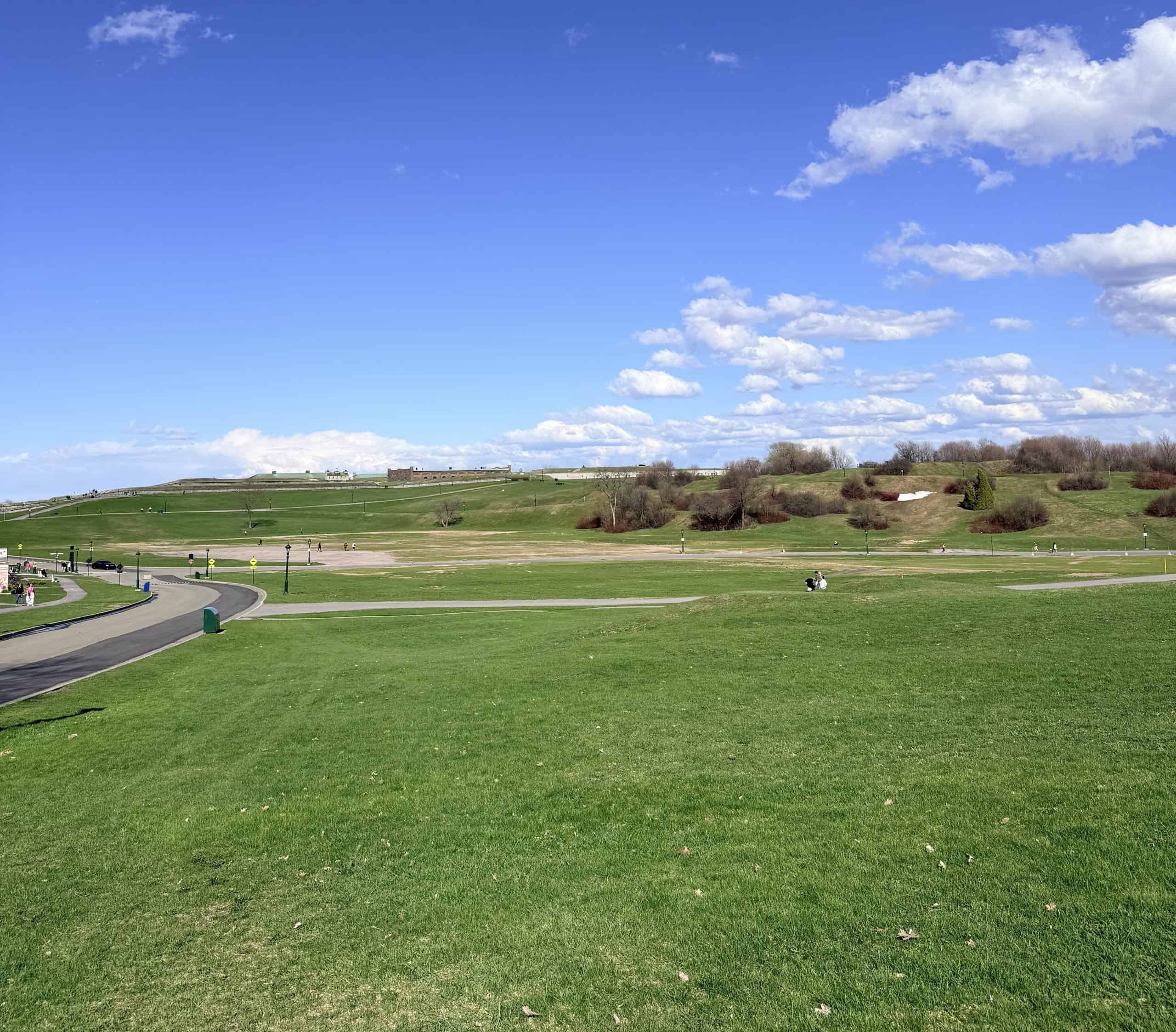 Green open fields at the Plains of Abraham in Quebec City under a blue sky