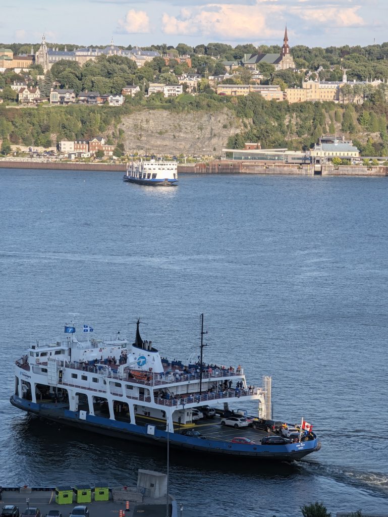Québec–Lévis ferry crossing the St. Lawrence River with the Lévis shoreline in the background.