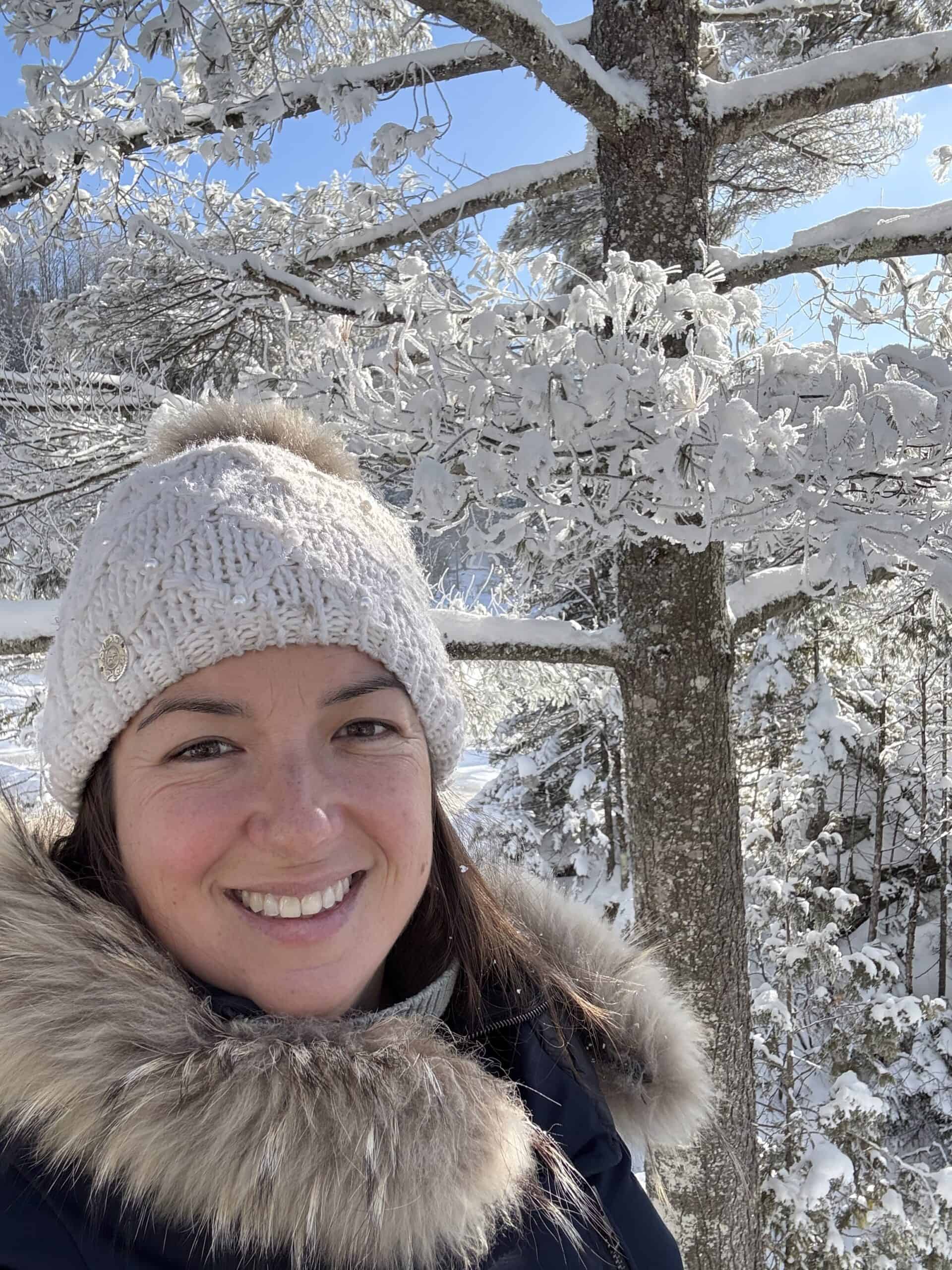 Annie outdoors in a snowy forest in Quebec City during winter