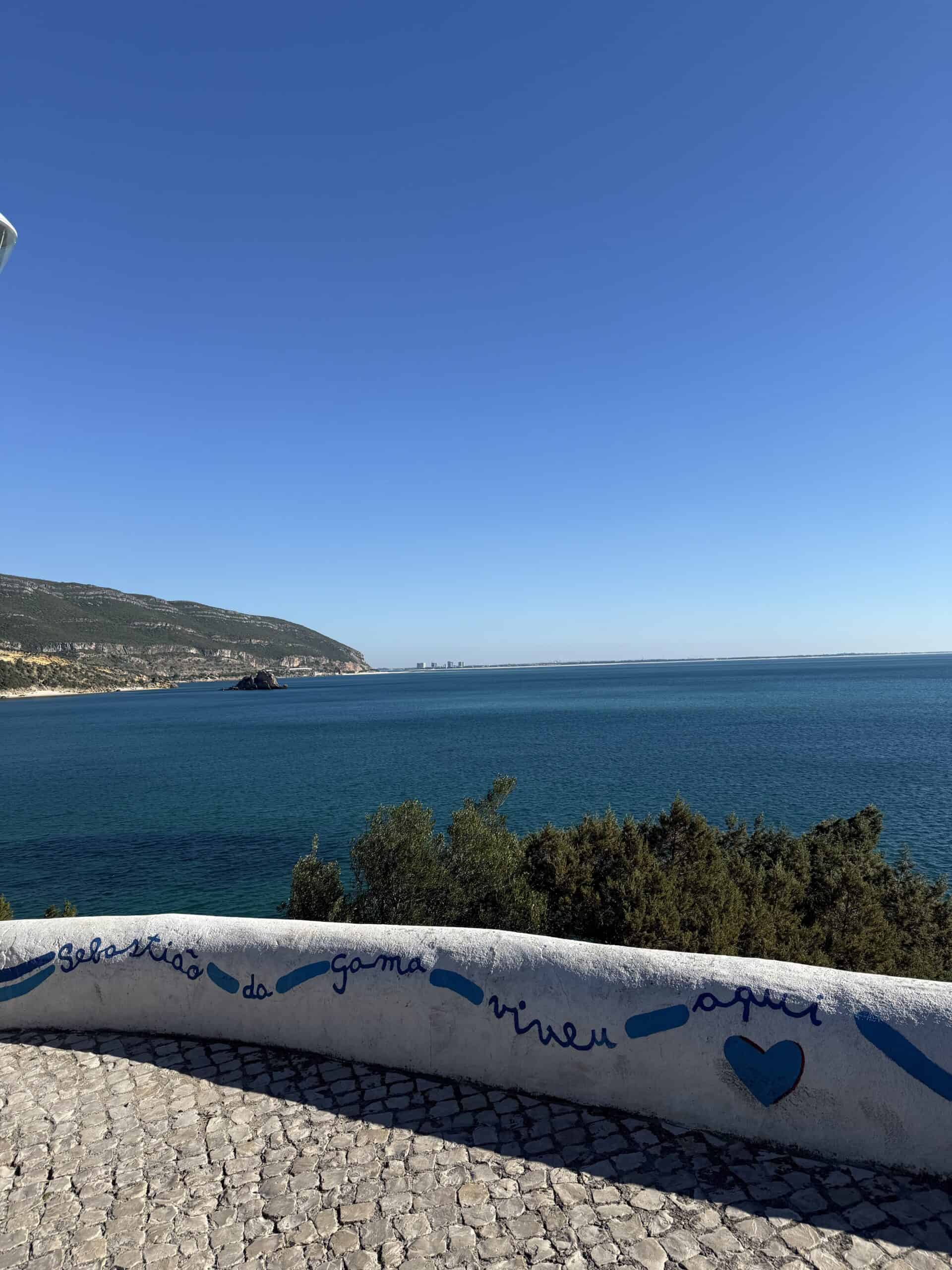 Panoramic view of the Arrábida coastline and deep blue sea from a scenic viewpoint overlooking the Sado Estuary