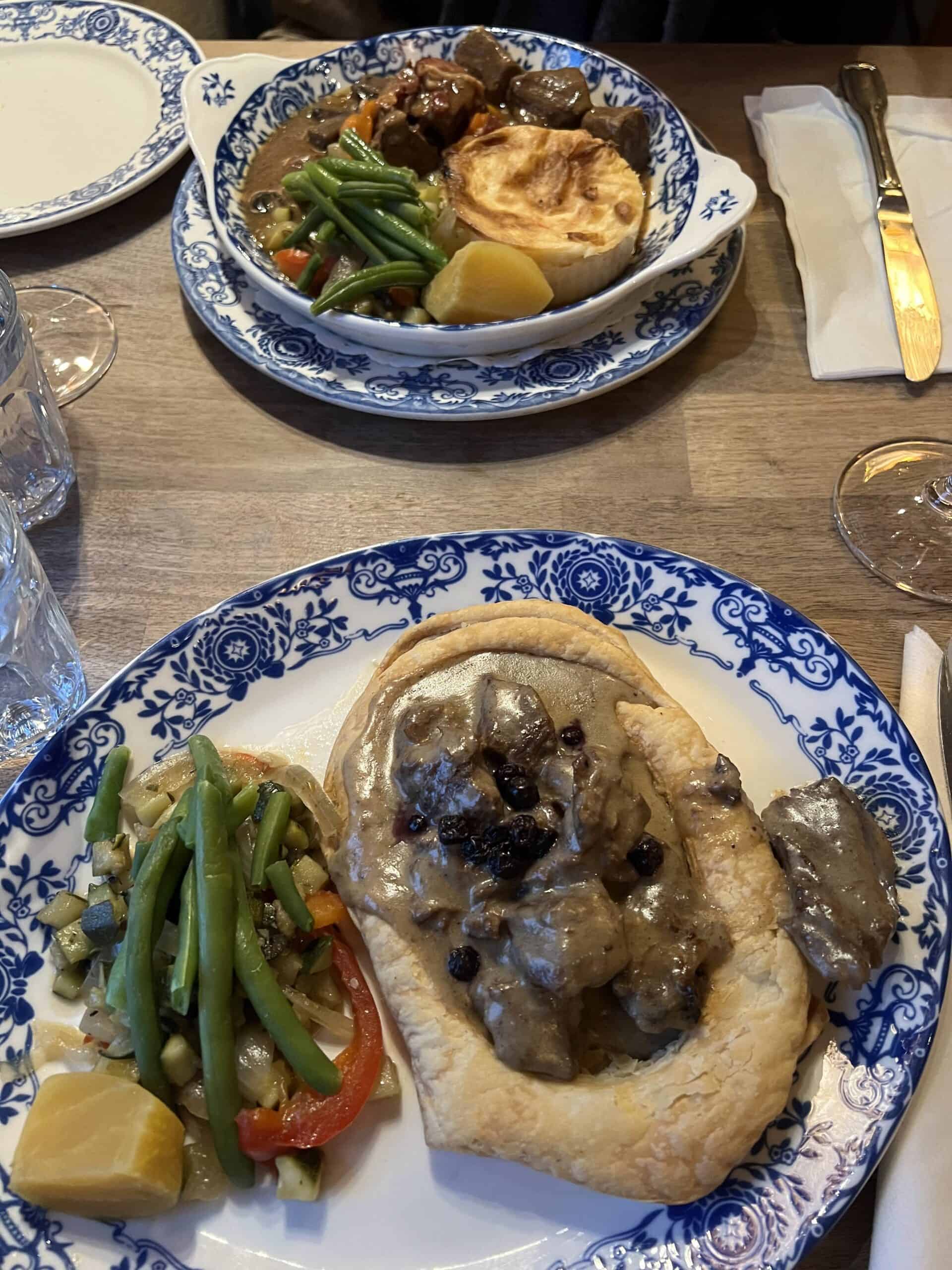 Traditional Québécois meat dishes served in pastry with gravy and seasonal vegetables at Aux Anciens Canadiens restaurant in Old Quebec City.