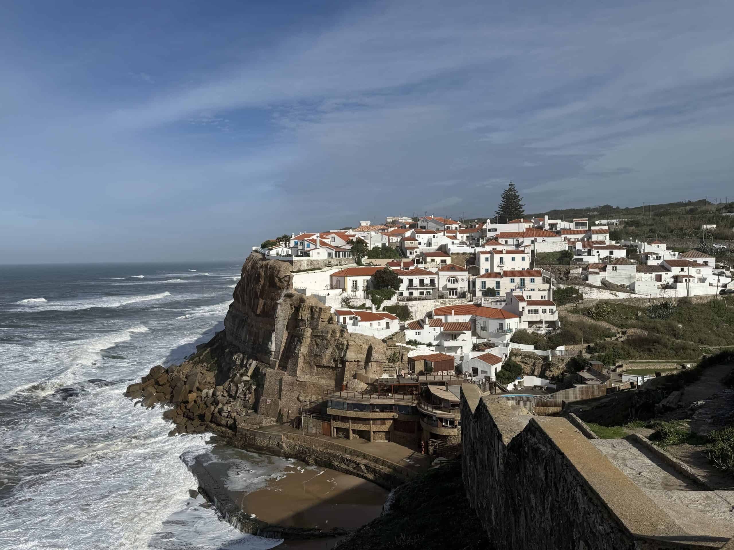 Whitewashed houses of Azenhas do Mar perched above the Atlantic coast in Portugal