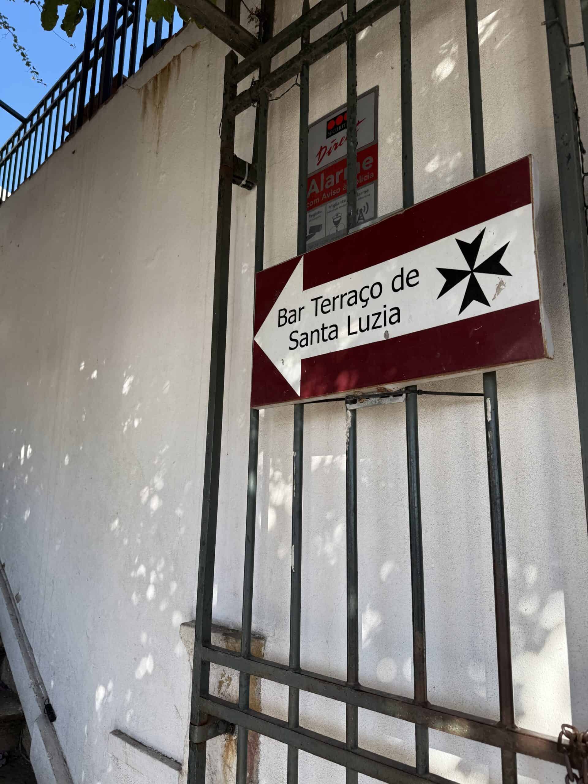 Directional sign for Bar Terraço de Santa Luzia near the Miradouro de Santa Luzia viewpoint in Alfama, Lisbon.