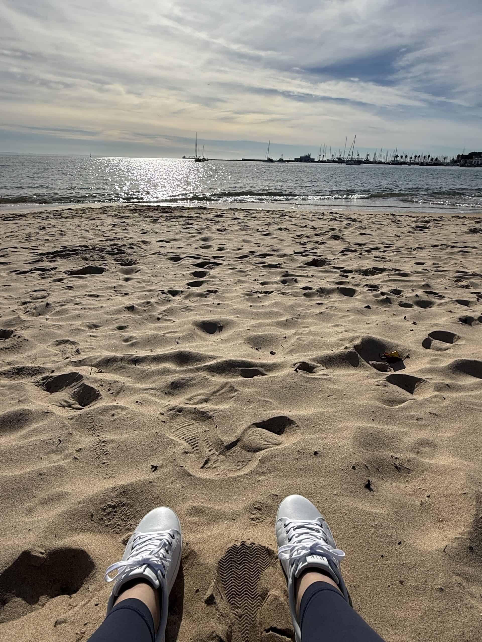 Relaxing on the sandy beach overlooking the ocean in Cascais, Portugal