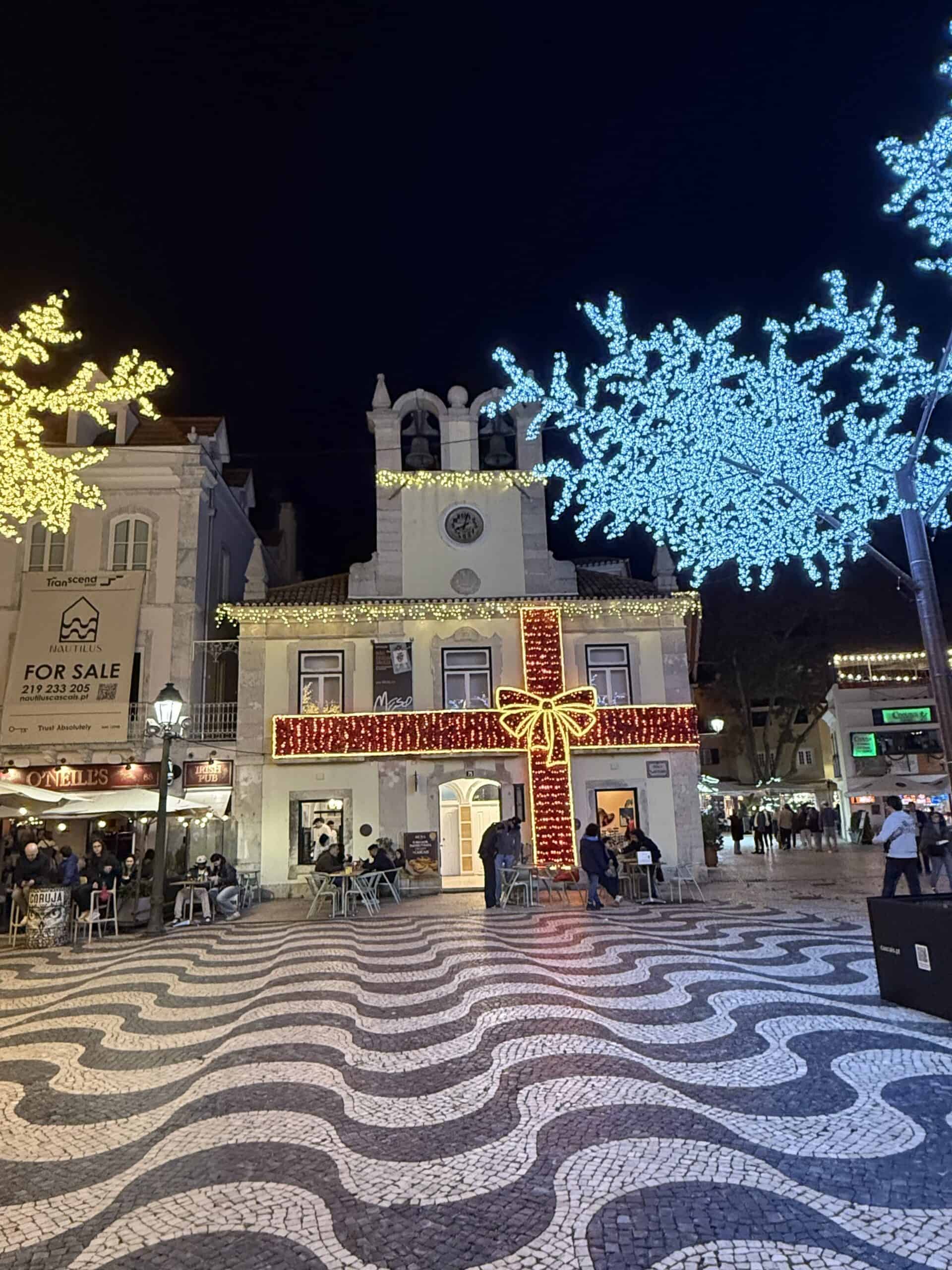 Christmas lights illuminating the town square in Cascais, Portugal, during the festive season.