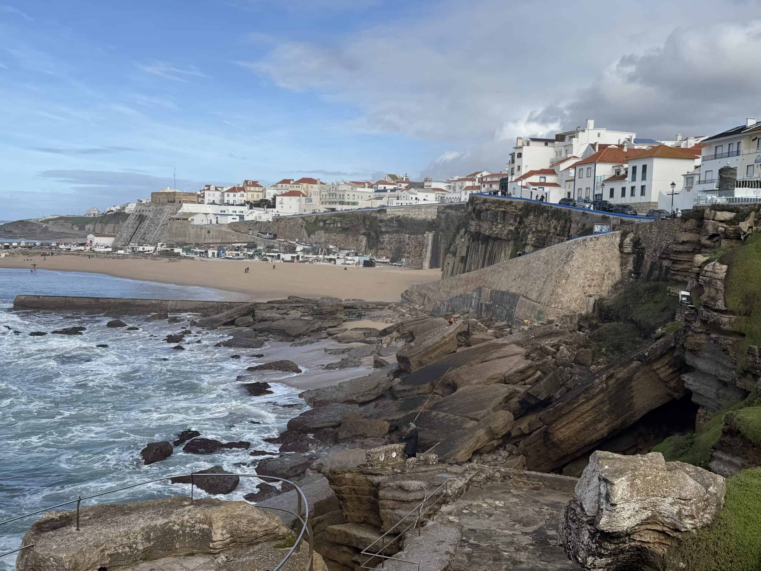 Rocky coastline and whitewashed buildings in Ericeira, Portugal