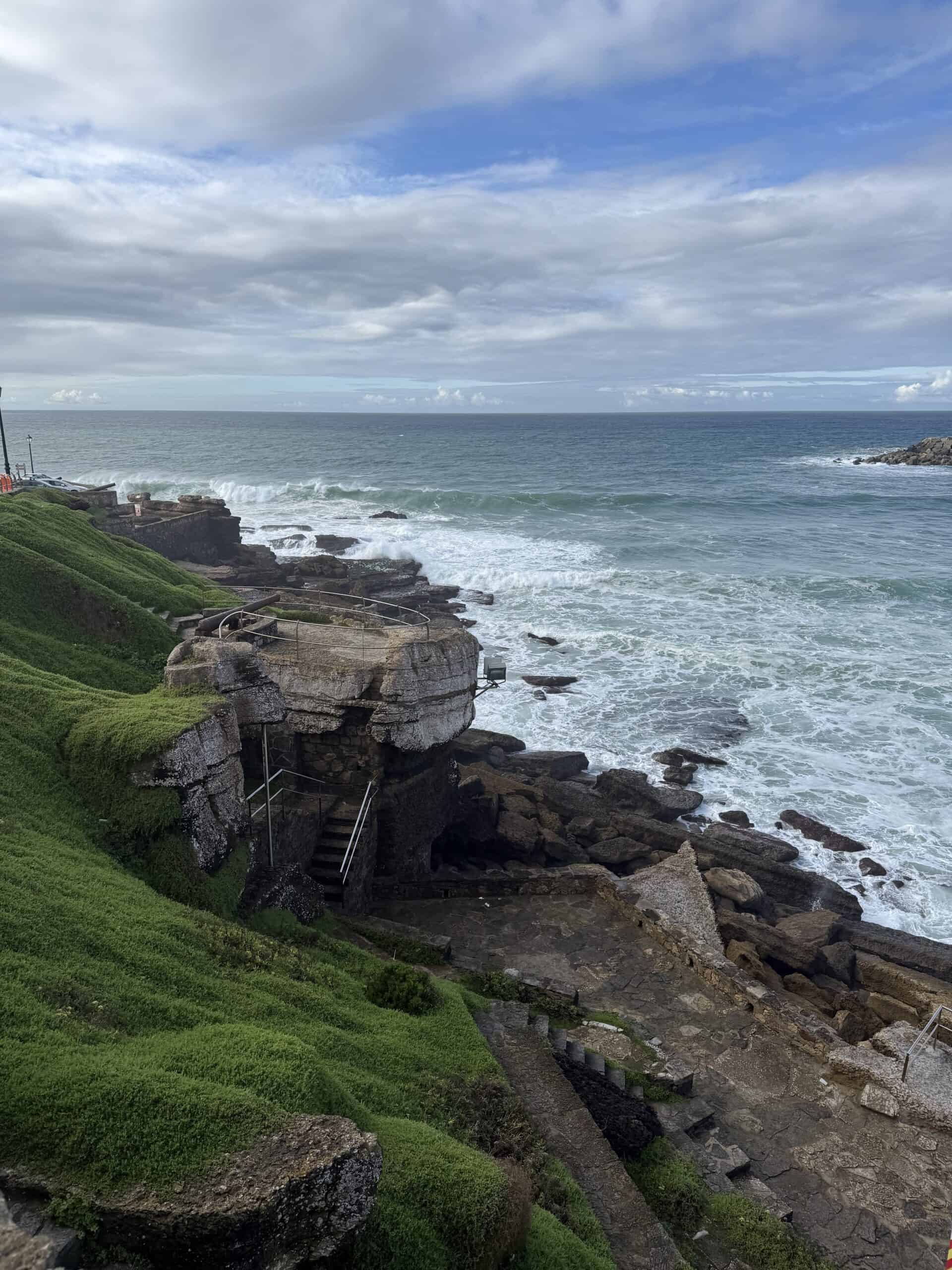 Rocky Atlantic coastline with stone steps and ocean views in Ericeira, Portugal.