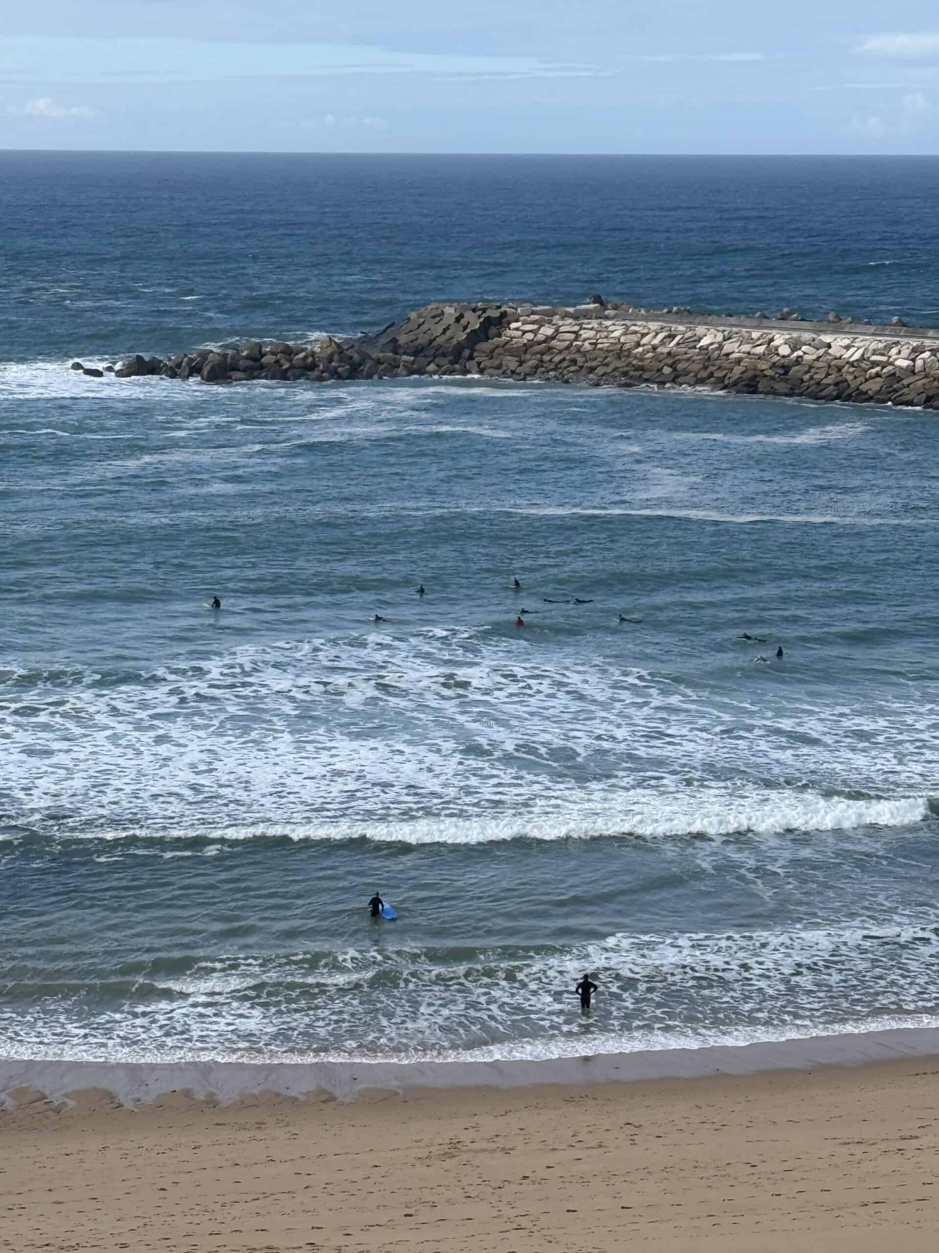 Surfers at a beach along the Atlantic coast in Ericeira, Portugal.
