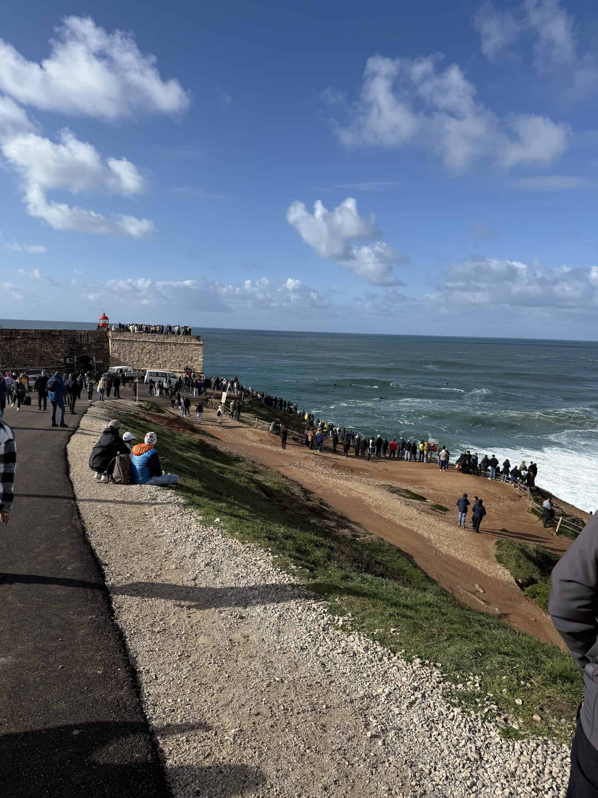 Nazaré lighthouse and giant Atlantic waves viewed from the coastal headland in Portugal