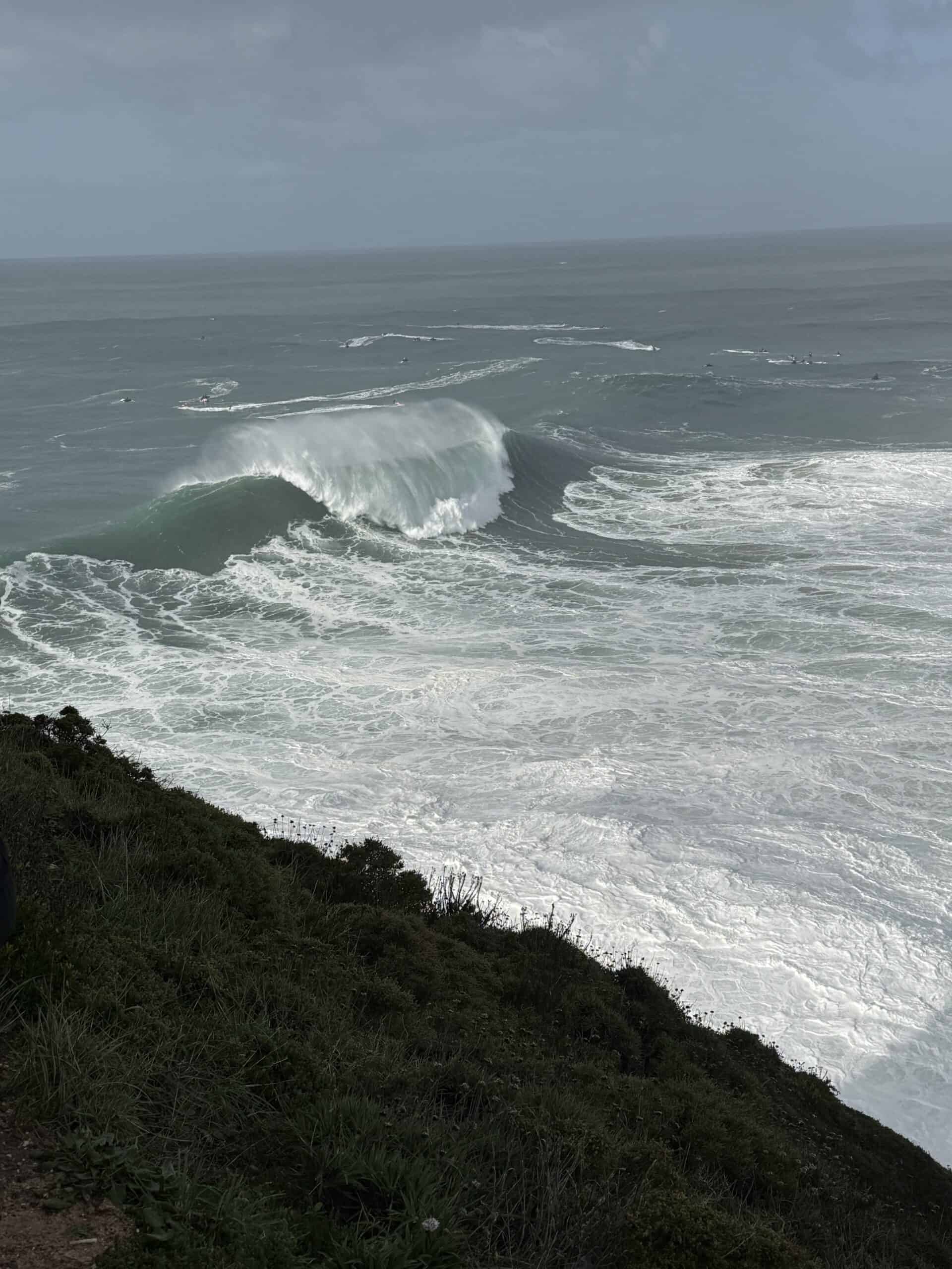 Enormous Atlantic wave curling and breaking into whitewater at Praia do Norte in Nazaré, Portugal