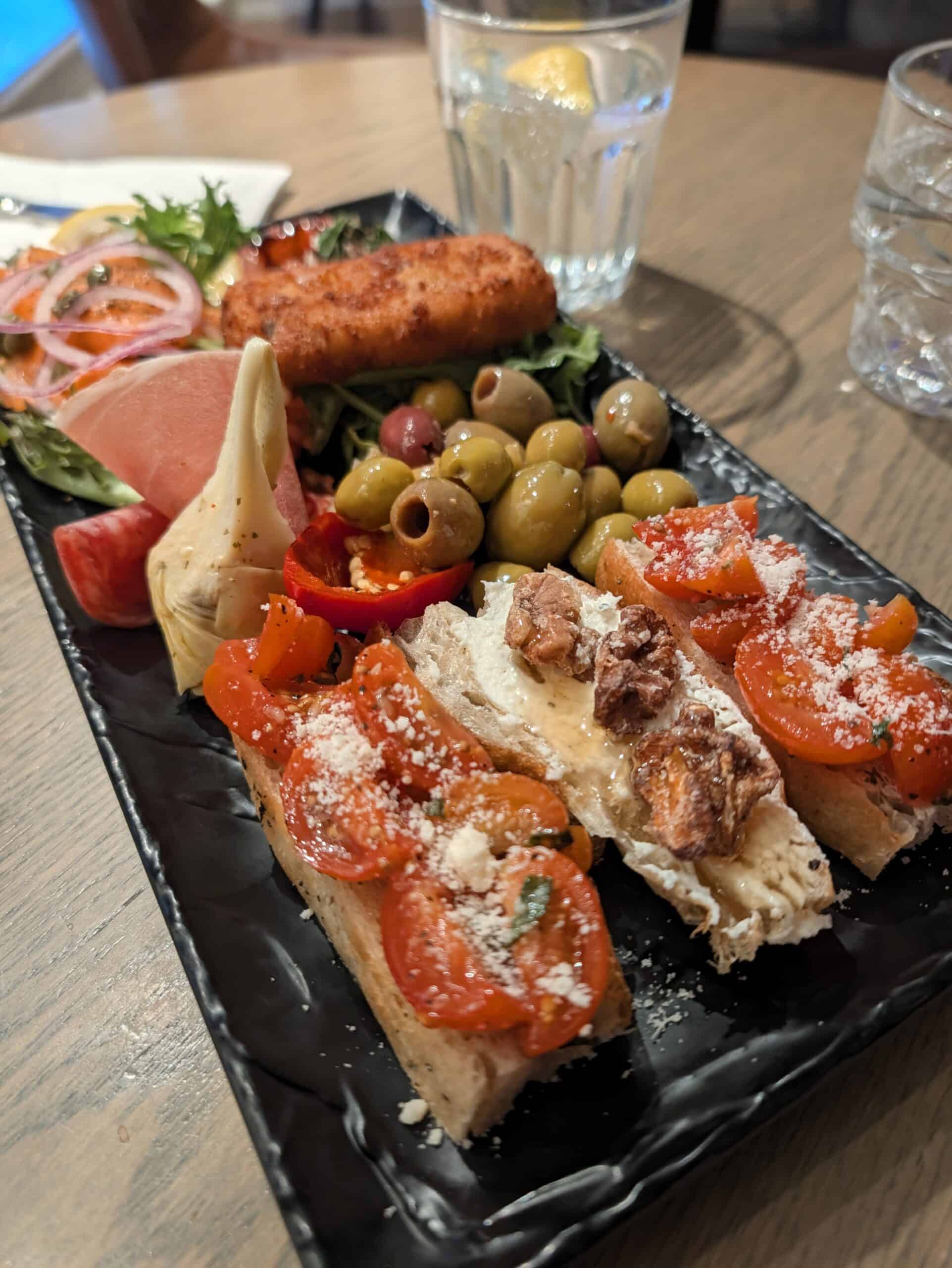 Antipasto platter with bruschetta, olives, cured meats and artichokes at Portofino restaurant in Old Quebec City.