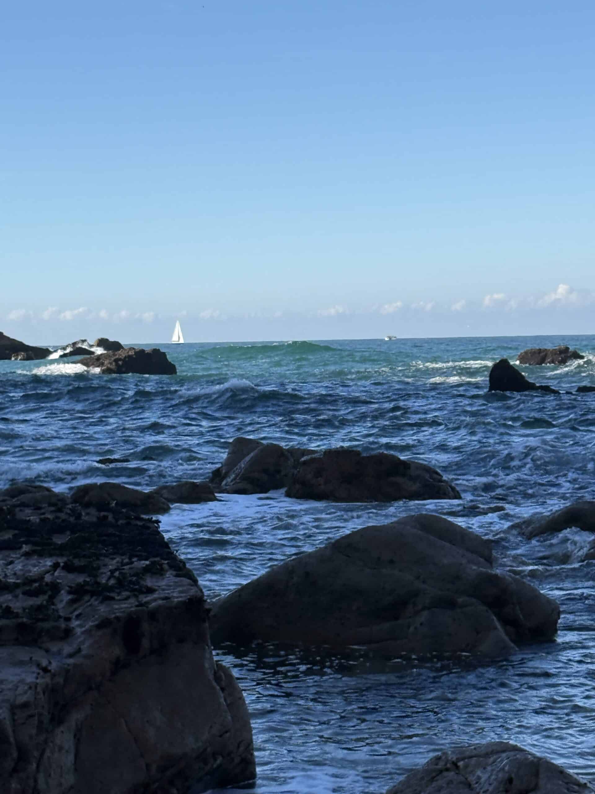 Atlantic waves rolling onto the rocky shoreline at Praia da Ursa near Cabo da Roca