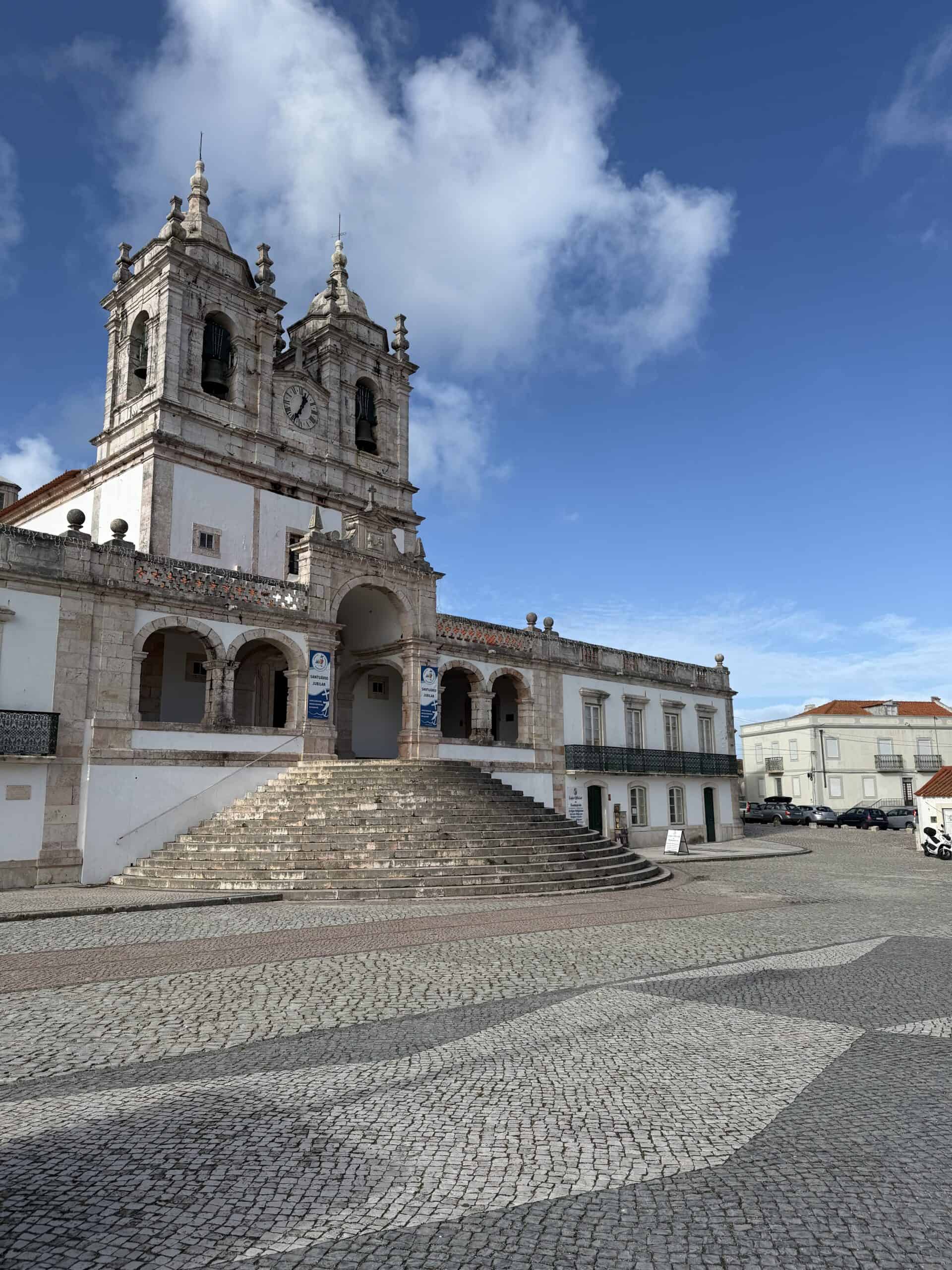 Sanctuary of Nossa Senhora da Nazaré with twin bell towers and a stone staircase in the Sítio district of Nazaré, Portugal