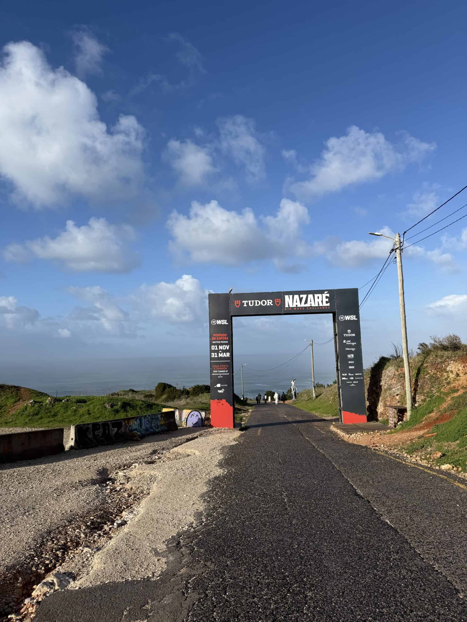 TUDOR Nazaré Big Wave Challenge entrance arch along the road leading toward the lighthouse at Praia do Norte, Portugal